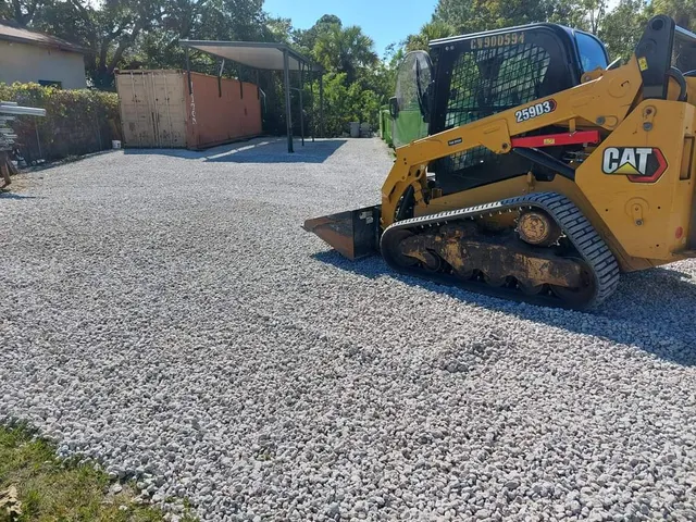 Gravel driveway base spread with a skid steer